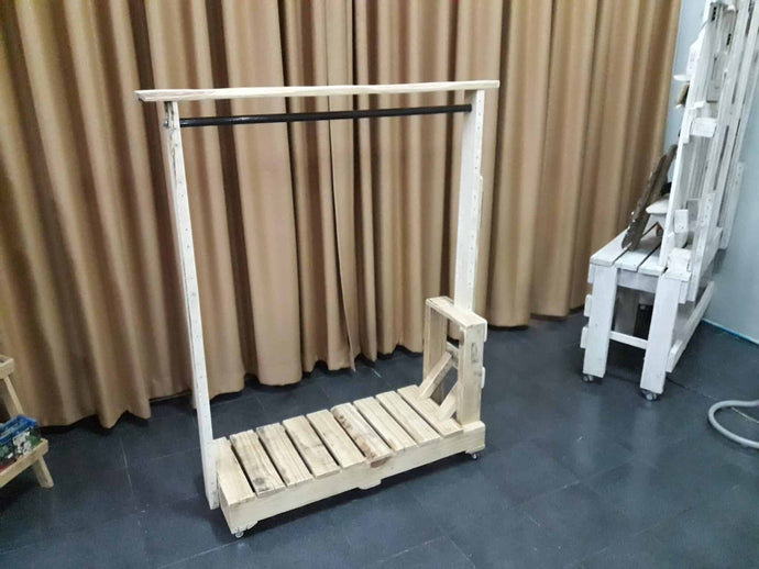 Clothes rack inspired by pallet truck, natural finish lightly sanded, all screwed joints, steel broom handle for hanger pole fixed wheels one end castoring the other end, cupboard handle for ease of moving.